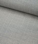 Rolled Bampton Ink upholstery fabric showcasing the woven herringbone chevron pattern in ink blue and ivory, perfect for curtains, blinds and upholstery projects.