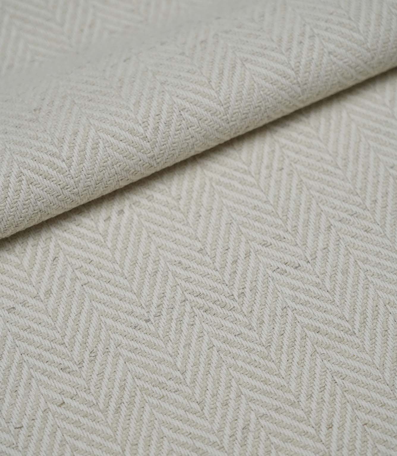 Folded Bampton Jasmine woven fabric showing its soft texture and classic herringbone design.
