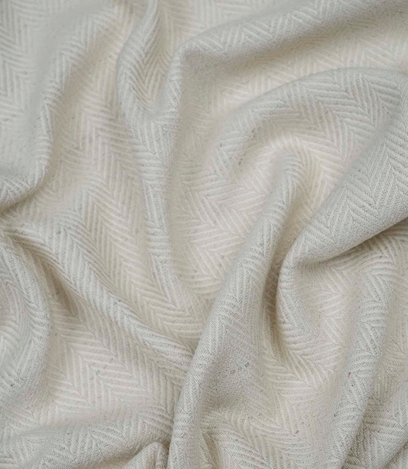 Draped Bampton Jasmine woven herringbone fabric demonstrating its soft handle, ideal for curtains, blinds and cushions.