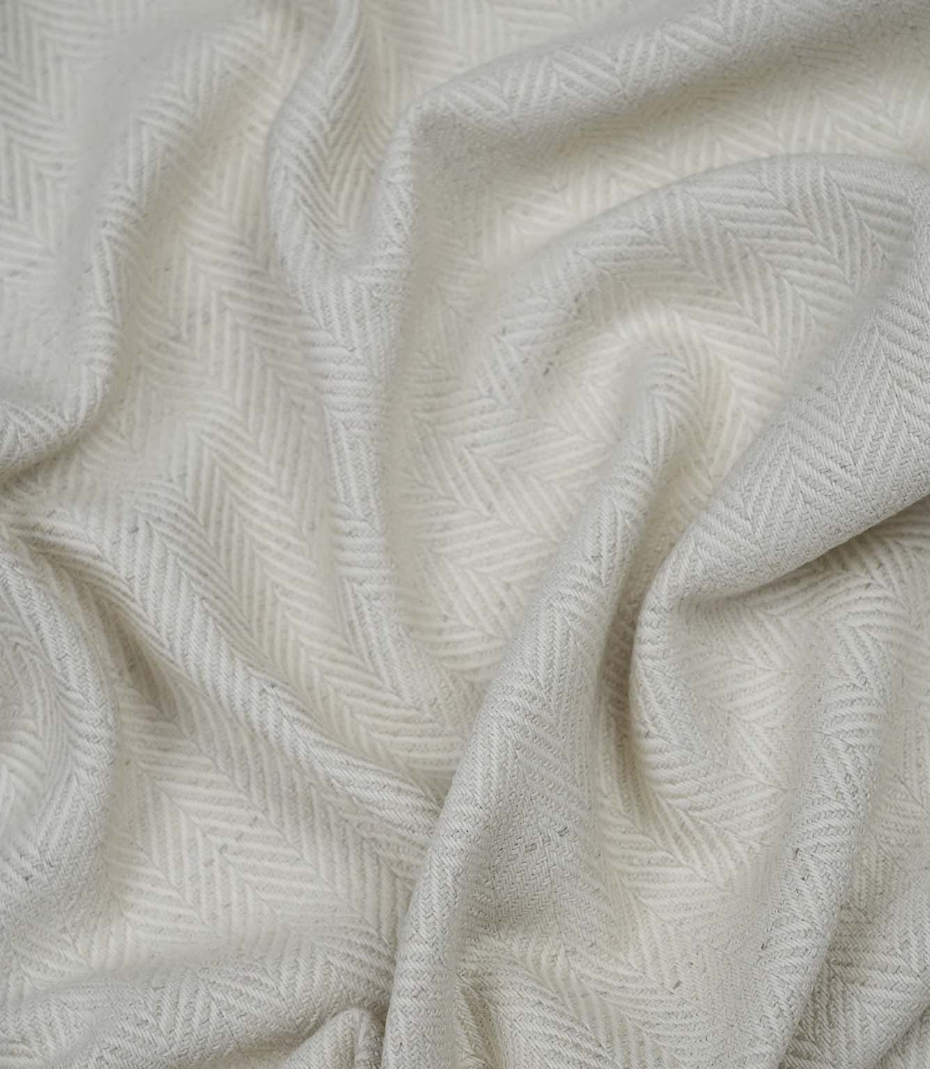 Draped Bampton Jasmine woven herringbone fabric demonstrating its soft handle, ideal for curtains, blinds and cushions.
