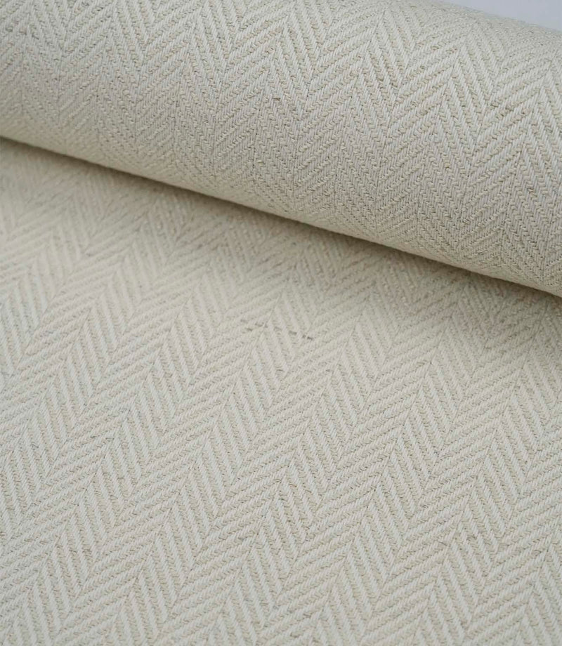 Wide view of Bampton Jasmine woven herringbone fabric showcasing the continuous classic pattern.