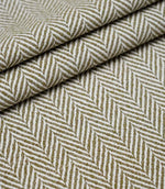 Layered folds of Bampton Matcha upholstery fabric displaying the textured woven herringbone pattern and fabric depth.