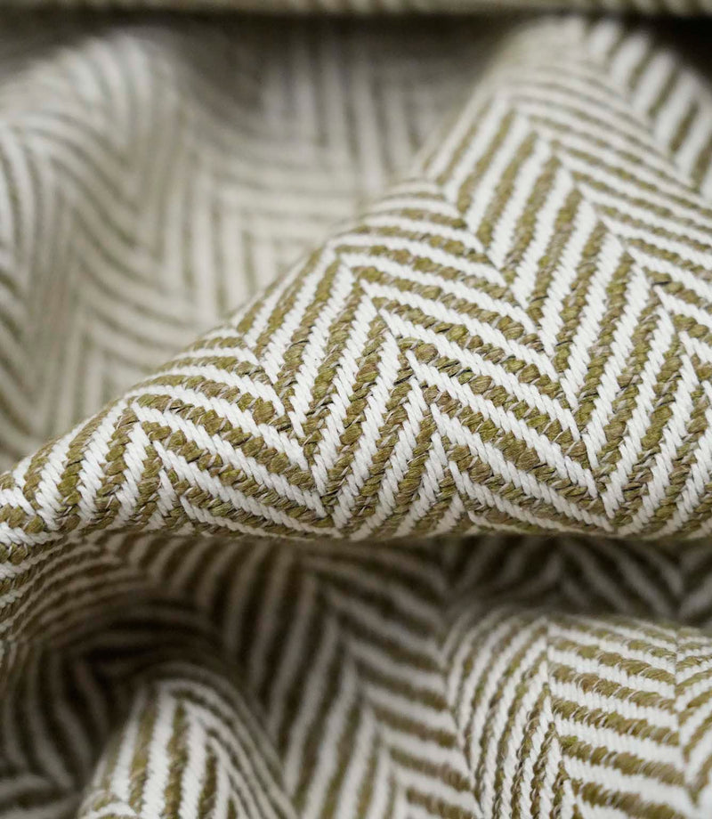 Close-up detail of Bampton Matcha upholstery fabric showing the woven herringbone texture, fabric weight and construction.