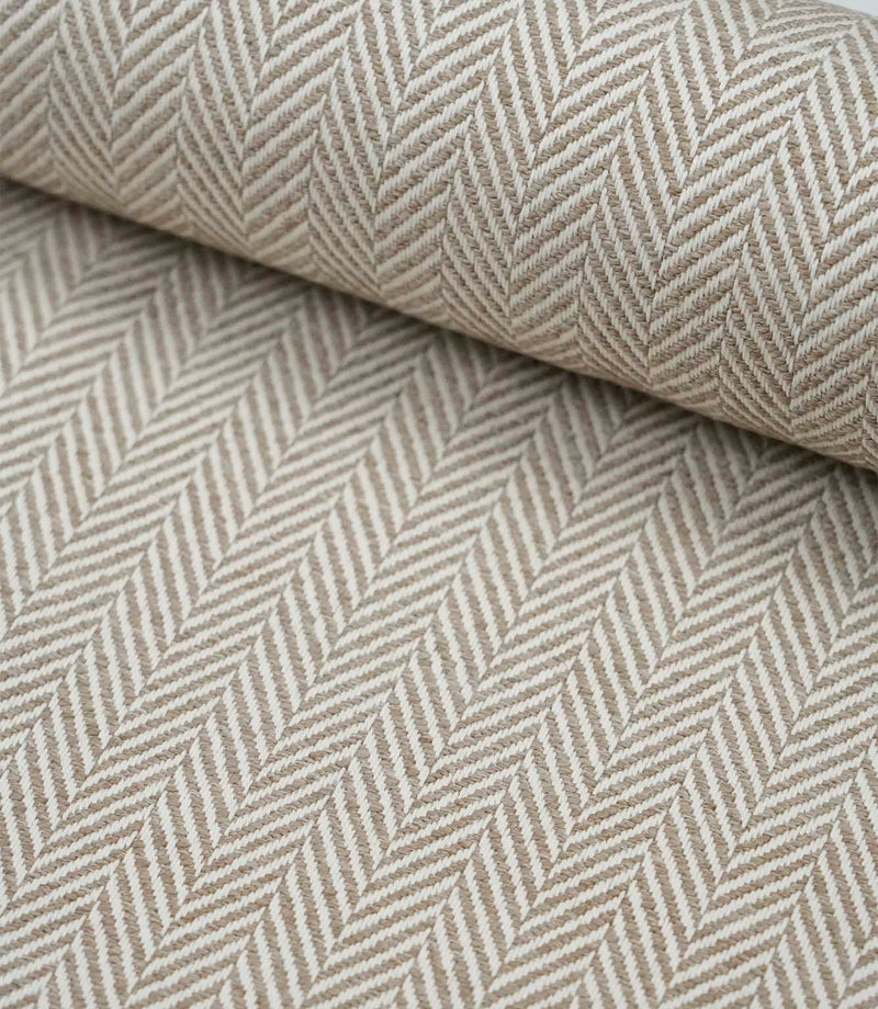 Rolled Bampton Taupe upholstery fabric featuring a woven herringbone chevron pattern in taupe and ivory, ideal for curtains, blinds and upholstery projects.