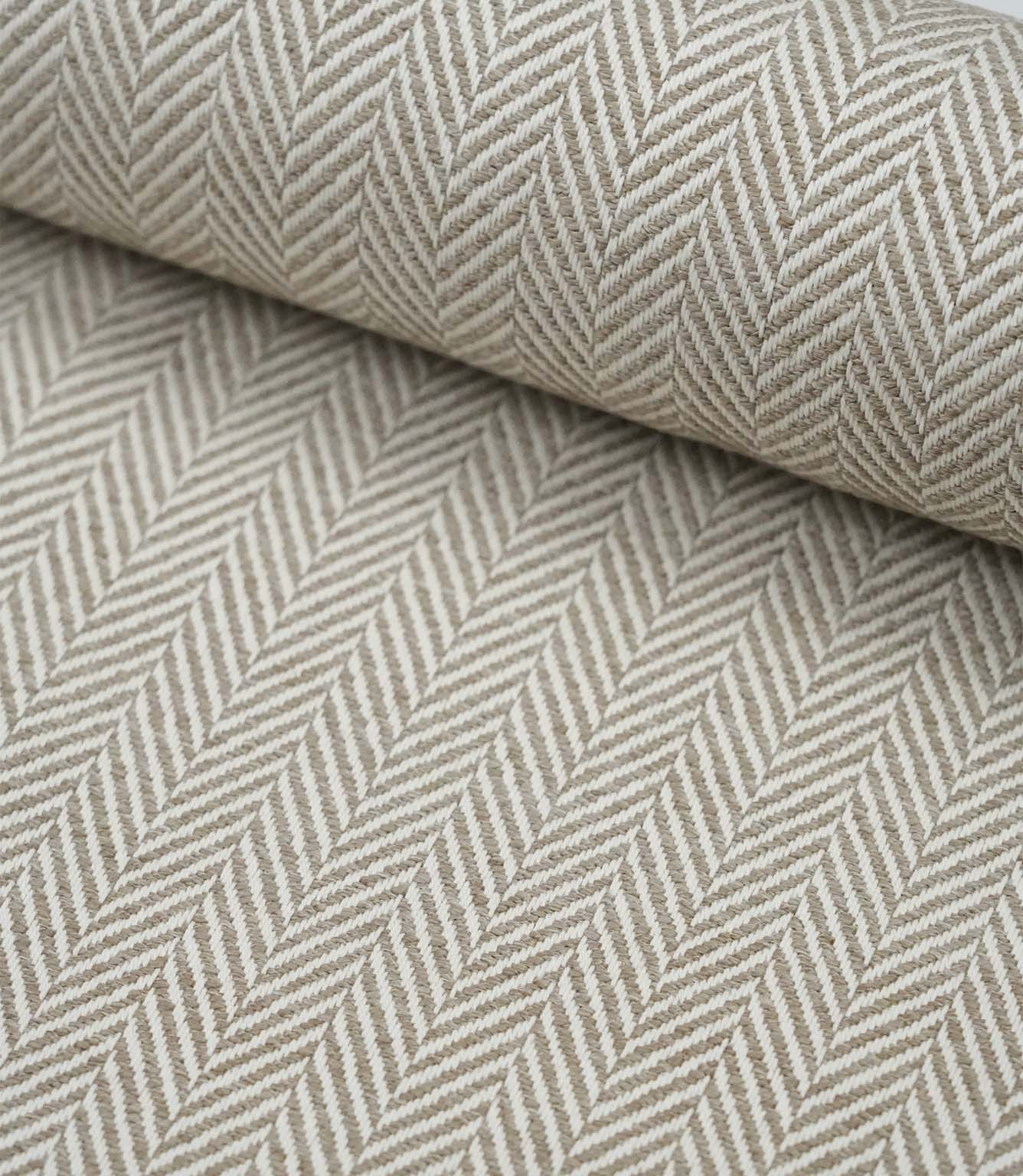 Rolled Bampton Taupe upholstery fabric featuring a woven herringbone chevron pattern in taupe and ivory, ideal for curtains, blinds and upholstery projects.
