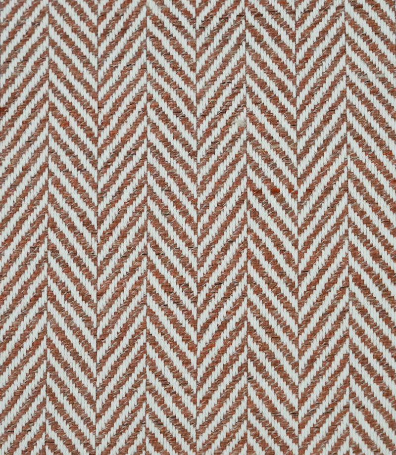 Bampton Terracotta woven herringbone upholstery fabric featuring a textured chevron pattern in warm terracotta and ivory, ideal for curtains, blinds, cushions and upholstery projects.