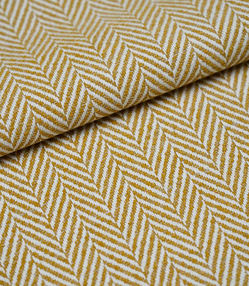 Folded Bampton Turmeric woven herringbone fabric showing the soft texture, fabric weight and classic chevron design.