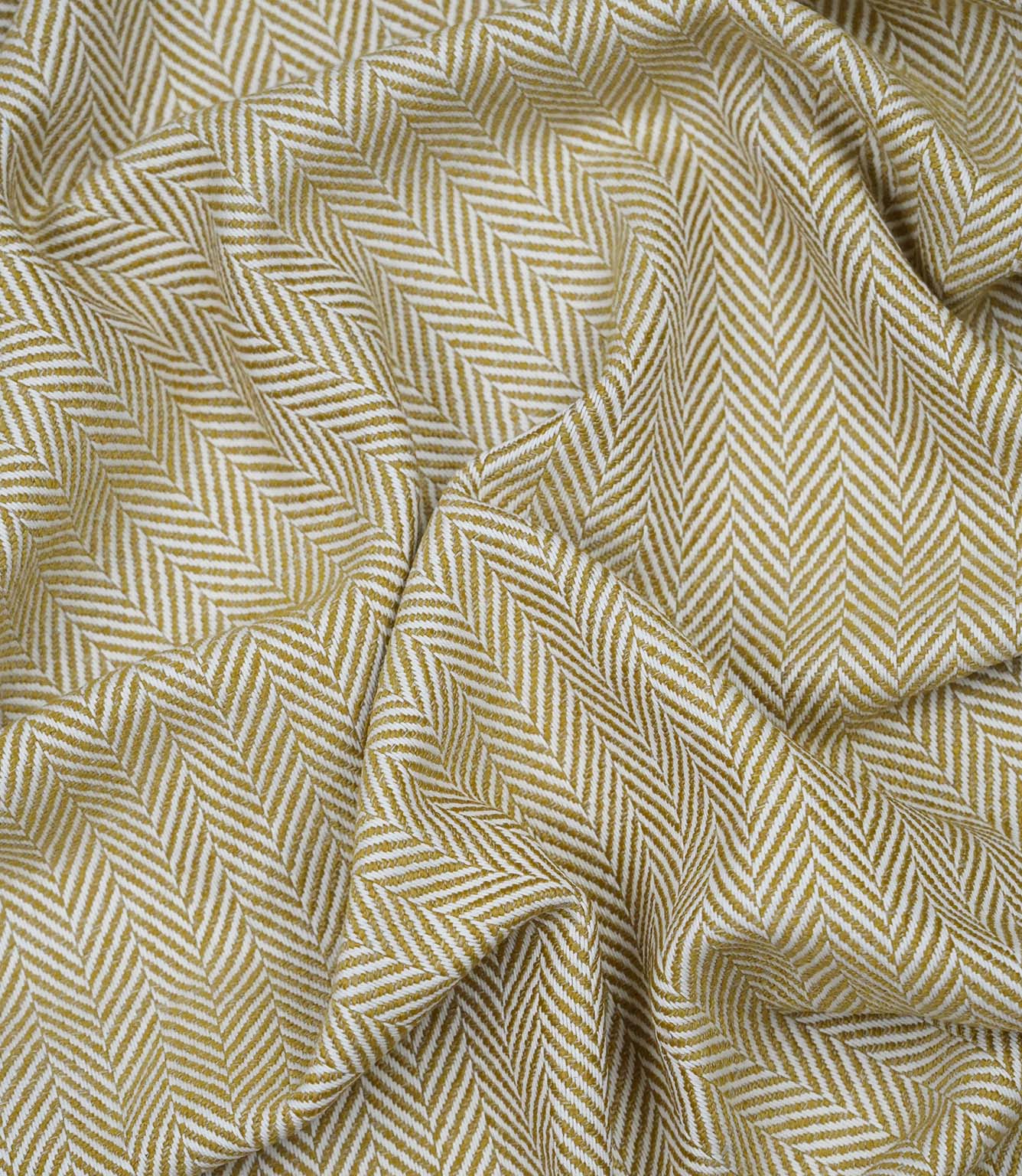 Draped Bampton Turmeric woven herringbone fabric demonstrating its soft handle and elegant drape, ideal for curtains, blinds and cushions.