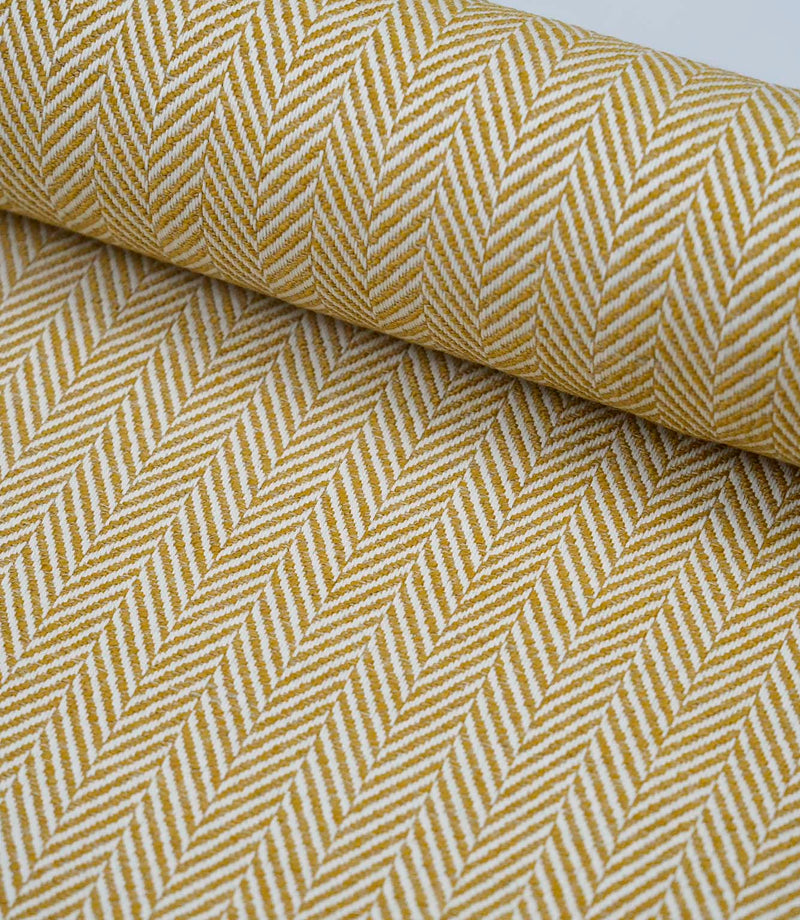 Wide view of Bampton Turmeric woven herringbone fabric showcasing the continuous chevron pattern across the fabric width.
