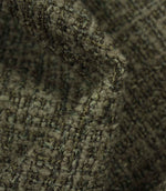Macro detail of Bellmere Forest upholstery fabric revealing the boucle yarns and rich woven texture.