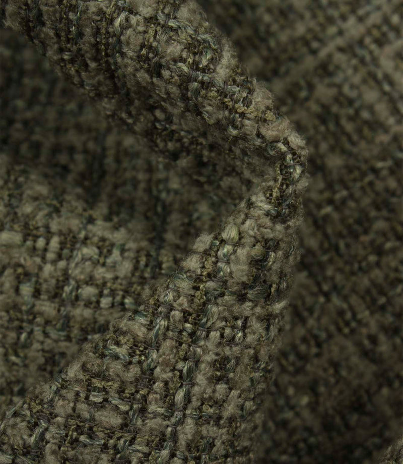 Macro detail of Bellmere Forest upholstery fabric revealing the boucle yarns and rich woven texture.