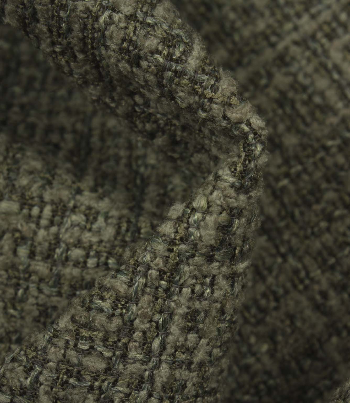 Macro detail of Bellmere Forest upholstery fabric revealing the boucle yarns and rich woven texture.