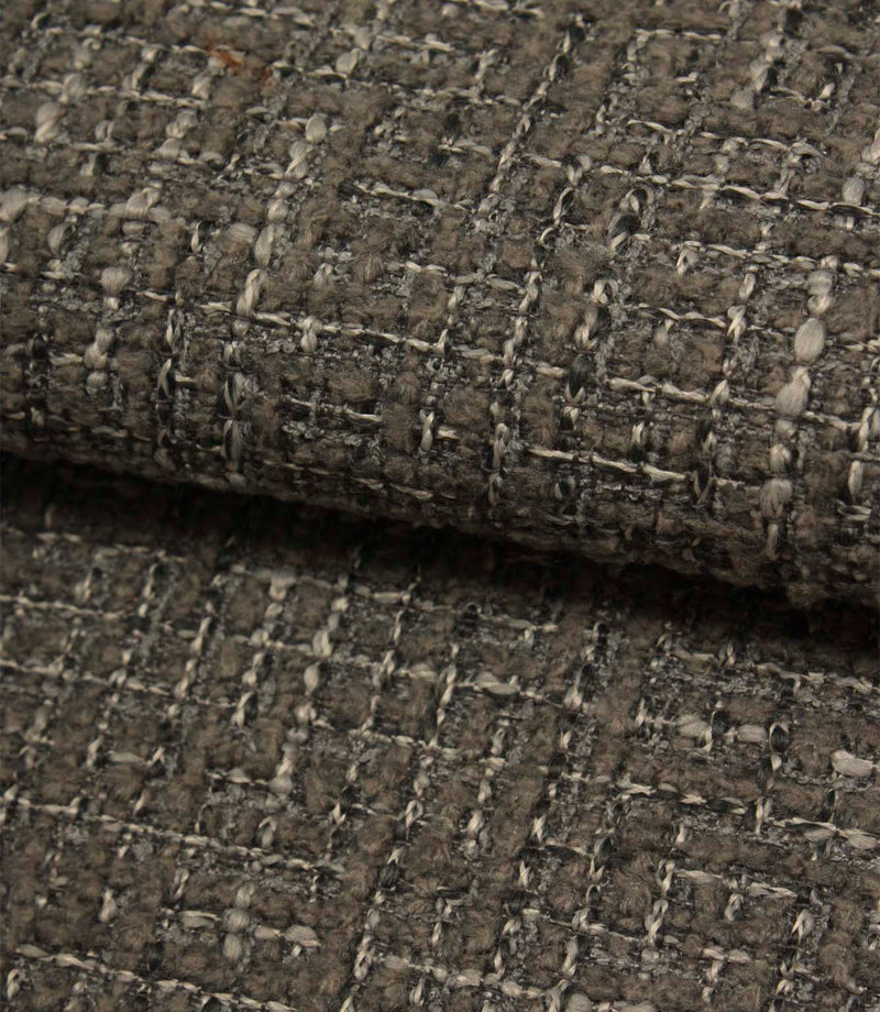 Rolled Bellmere Slate upholstery fire retardant fabric revealing the depth, durability and tactile boucle texture of the weave.