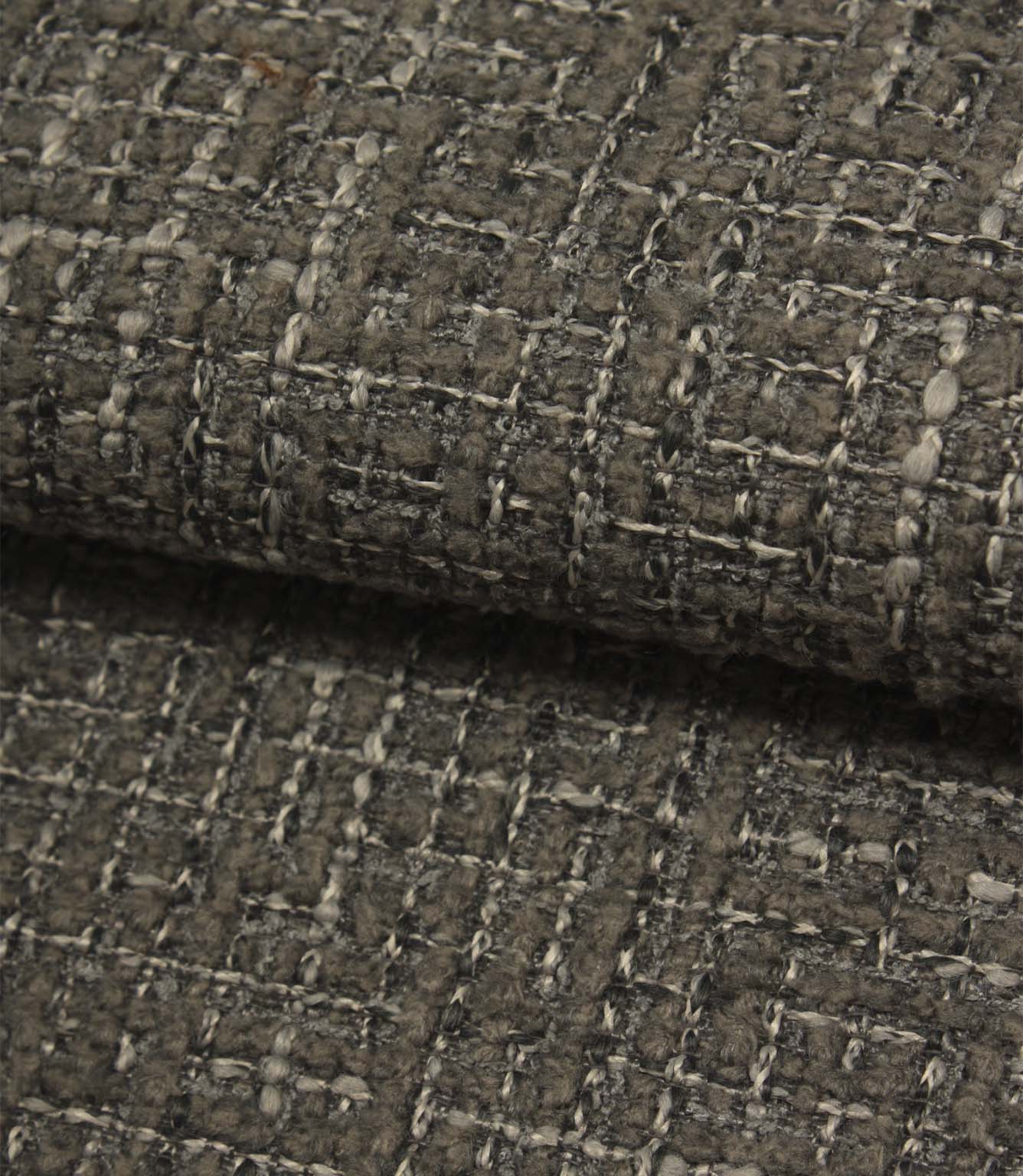 Rolled Bellmere Slate upholstery fire retardant fabric revealing the depth, durability and tactile boucle texture of the weave.