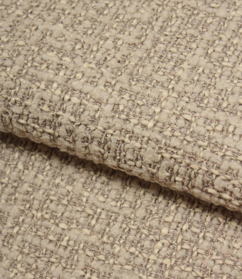 Rolled Bellmere Stone upholstery fire retardant fabric revealing the depth, durability and tactile boucle texture of the weave.