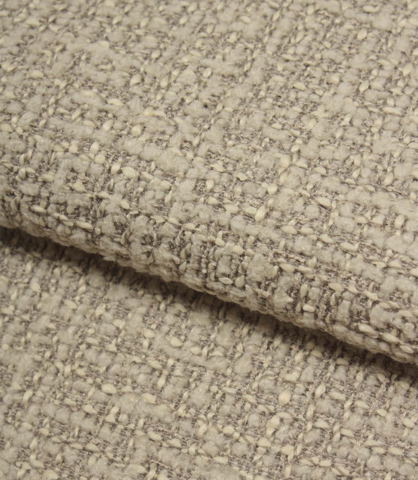 Rolled Bellmere Stone upholstery fire retardant fabric revealing the depth, durability and tactile boucle texture of the weave.