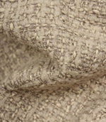 Macro detail of Bellmere Stone upholstery fabric showing the boucle yarns, textured weave and rich dimensional character.