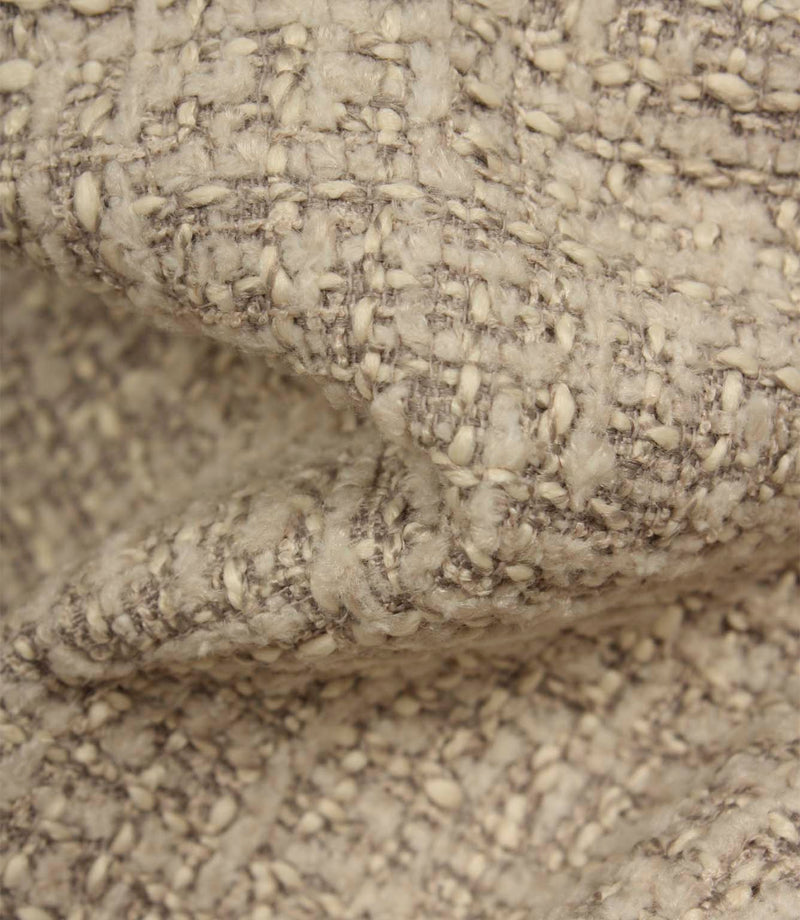 Macro detail of Bellmere Stone upholstery fabric showing the boucle yarns, textured weave and rich dimensional character.
