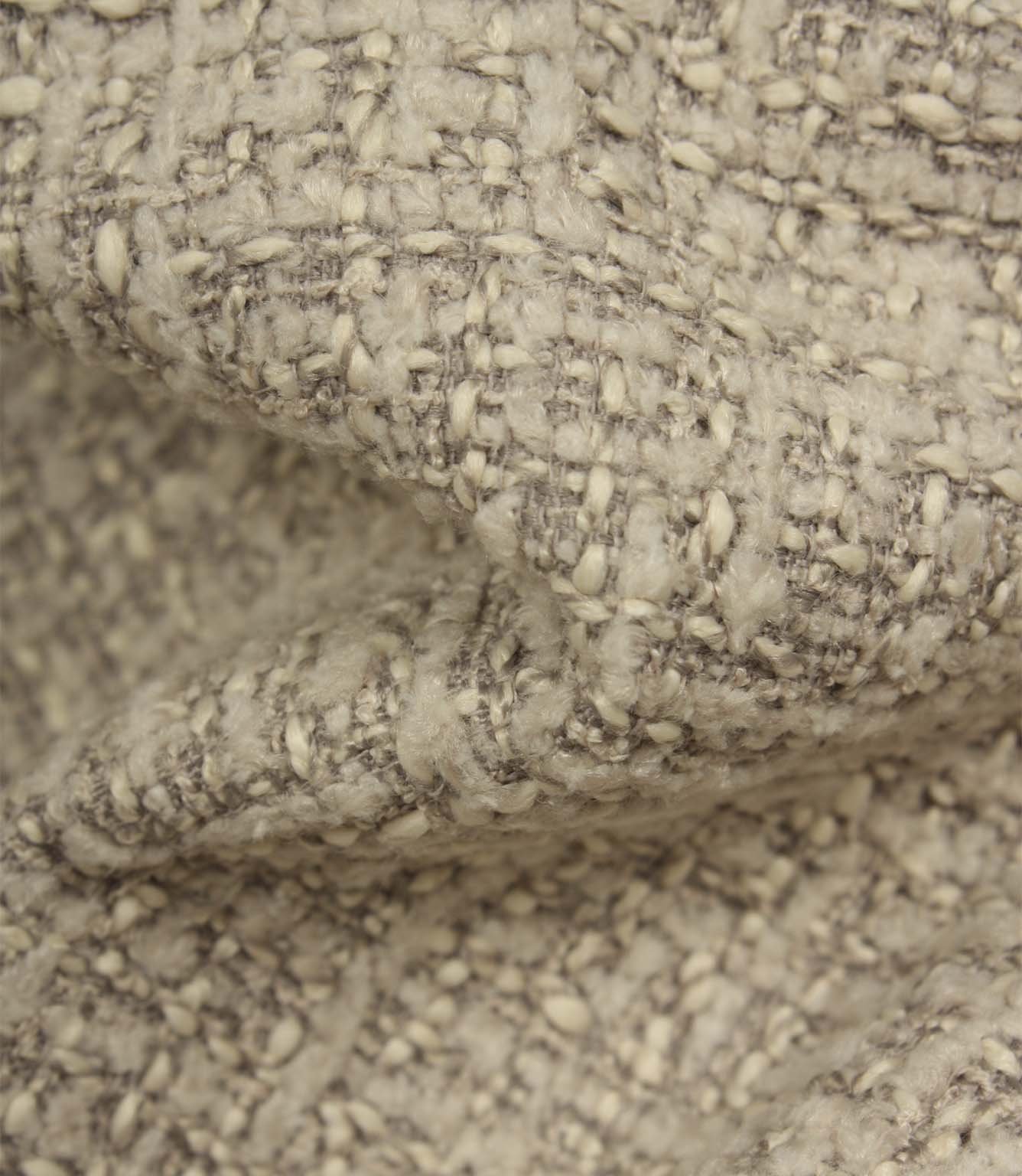 Macro detail of Bellmere Stone upholstery fabric showing the boucle yarns, textured weave and rich dimensional character.