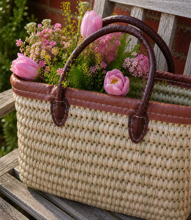 Woven basket tote bag with brown leather trim and handles