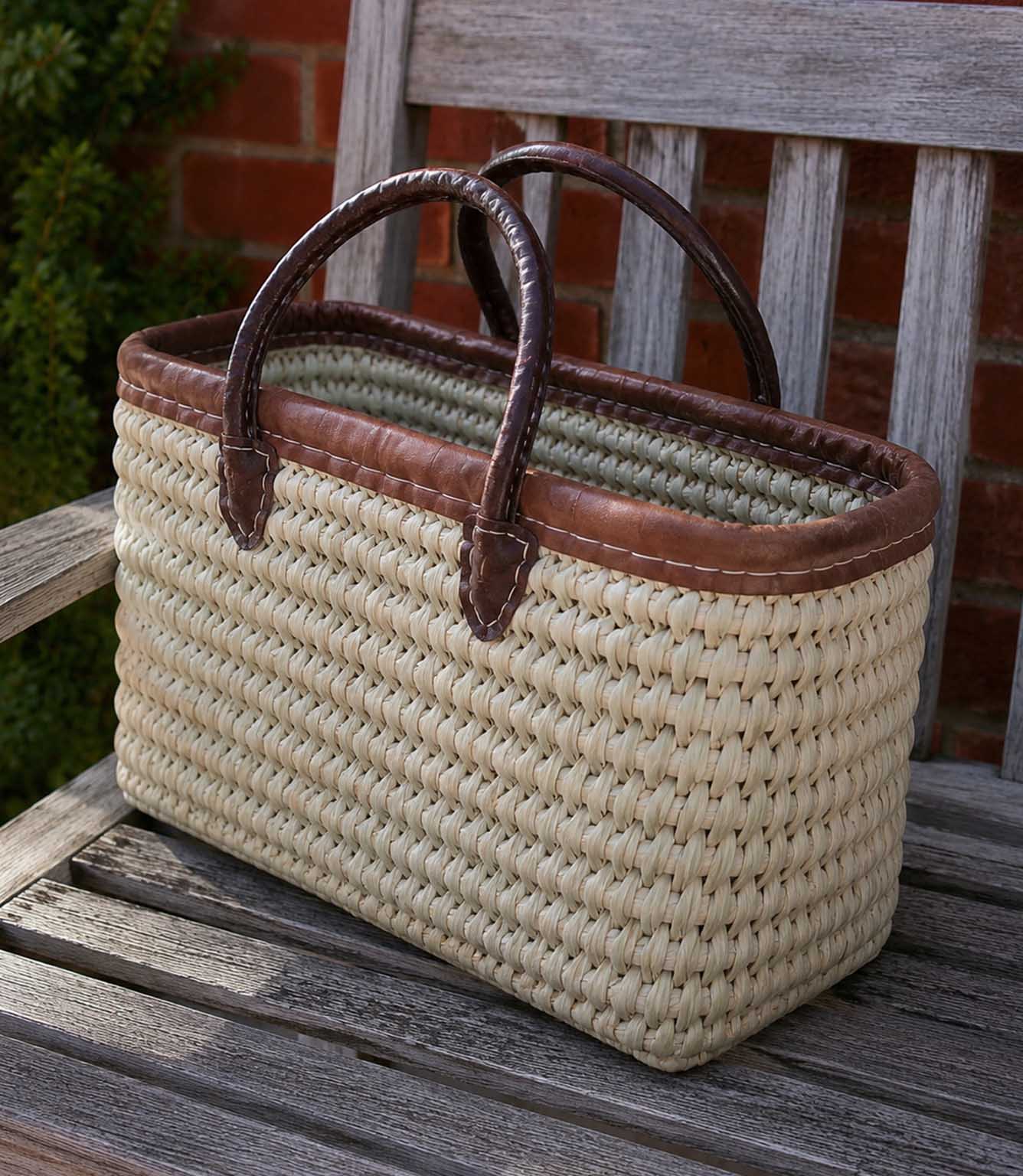 Woven basket tote bag with brown leather trim and handles