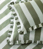 Detailed close-up of the Birdie Stripe Ruffle pillowcase and duvet cover in sage green and white, showing the wide scalloped stripe pattern, subtle woven texture and gathered ruffle trim.