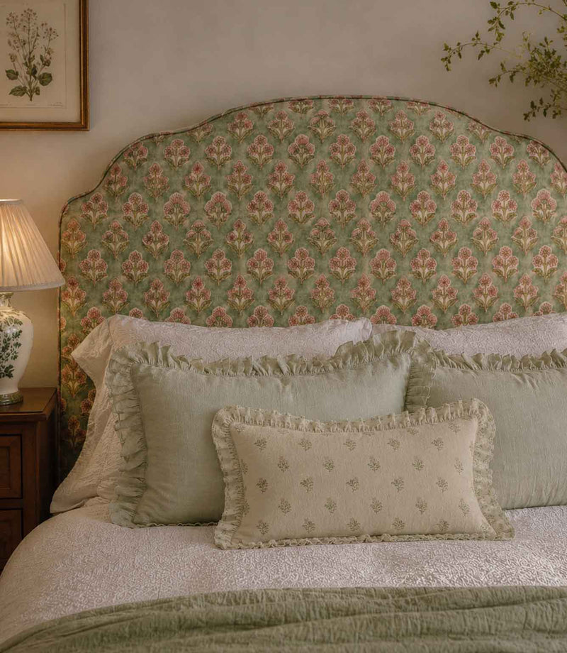 Bedroom with floral-patterned headboard and decorative pillows