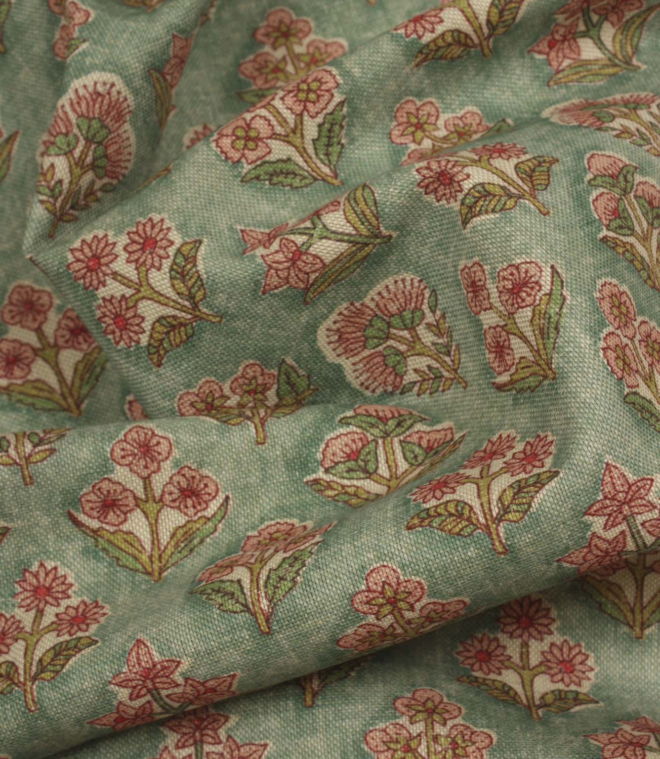 Draped floral fabric with repeating hand-drawn style blooms and a relaxed natural finish.