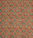 Boho Blossom ditsy floral fabric featuring small-scale botanical motifs in soft mustard yellow and slate blue on a warm terracotta background.