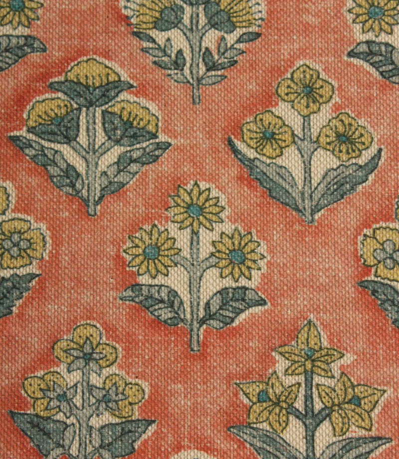 Close-up of Boho Blossom floral fabric showing detailed small-scale floral motifs in mustard yellow and slate blue on a textured terracotta woven base.