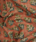 Draped Boho Blossom floral fabric with mustard yellow and slate blue botanical motifs across a warm terracotta woven surface.