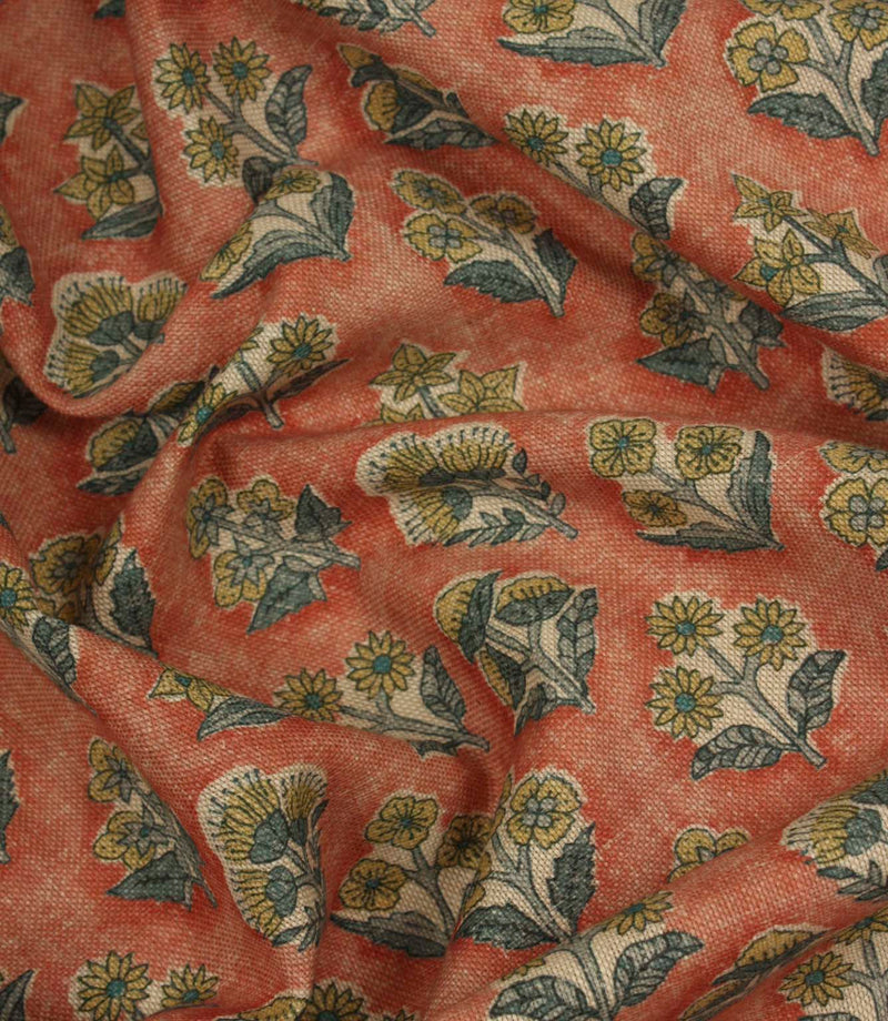 Draped Boho Blossom floral fabric with mustard yellow and slate blue botanical motifs across a warm terracotta woven surface.