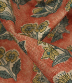 Close-up detail of Boho Blossom fabric showing the textured weave and ditsy floral pattern in mustard yellow and slate blue on terracotta fabric.