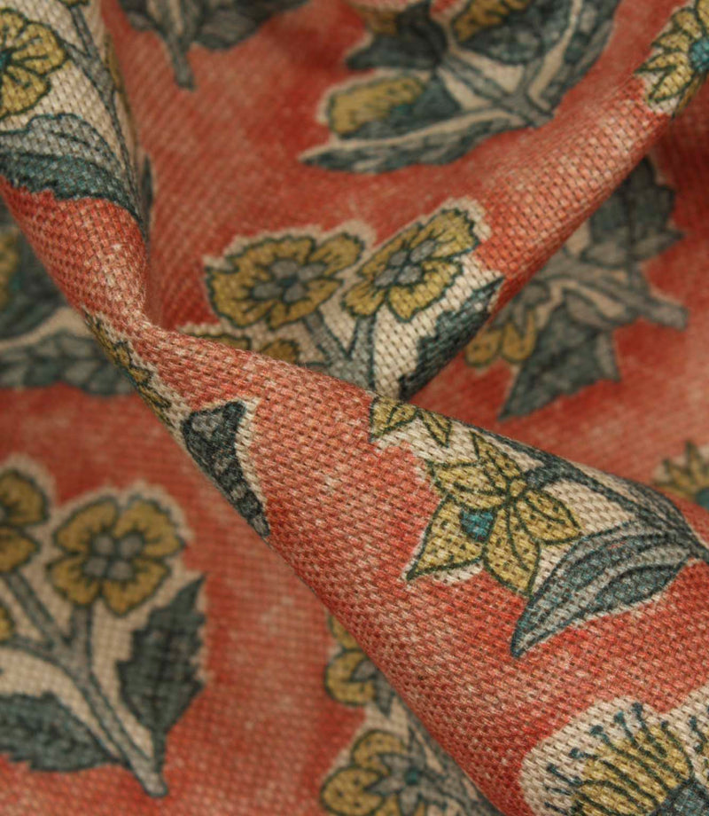 Close-up detail of Boho Blossom fabric showing the textured weave and ditsy floral pattern in mustard yellow and slate blue on terracotta fabric.