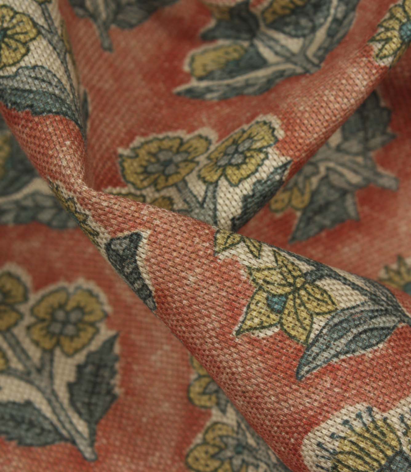 Close-up detail of Boho Blossom fabric showing the textured weave and ditsy floral pattern in mustard yellow and slate blue on terracotta fabric.