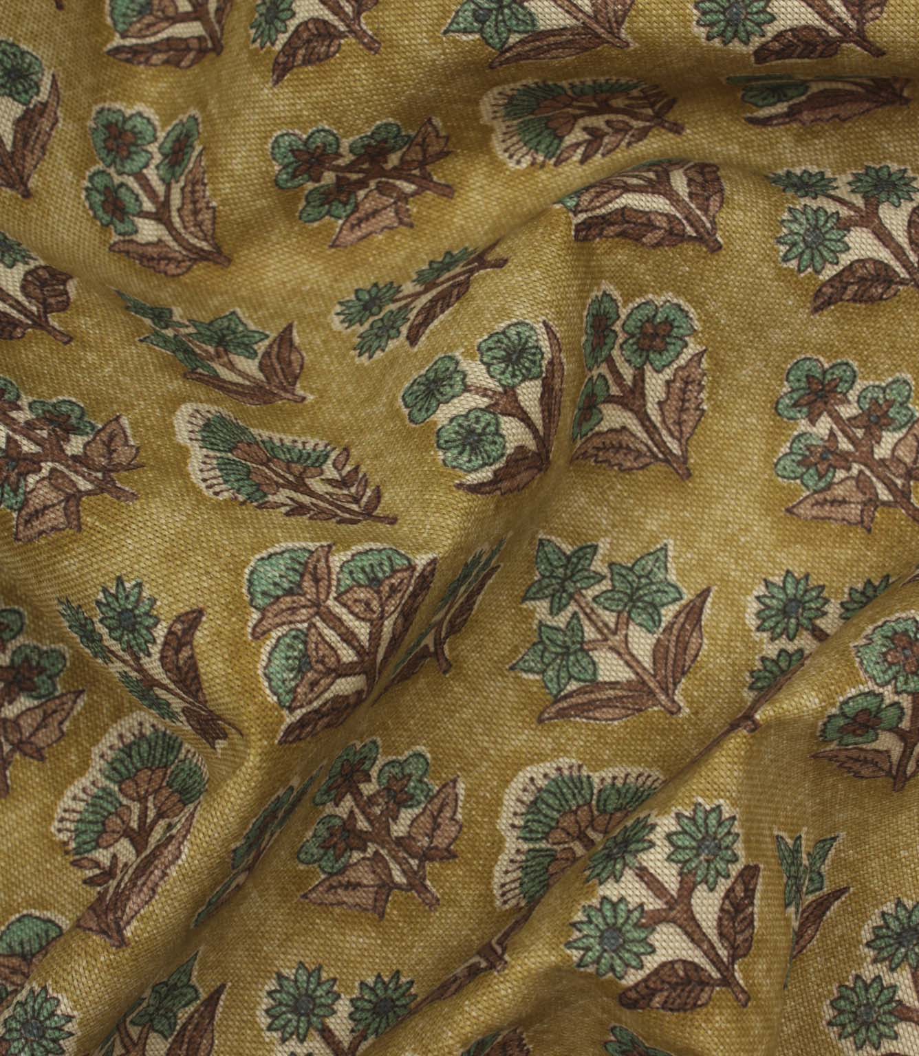 Draped Boho Blossom floral fabric with teal and brown floral motifs across a textured mustard yellow woven surface.