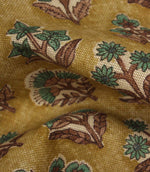 Close-up detail of Boho Blossom fabric showing the textured weave and teal floral design on a mustard yellow background.