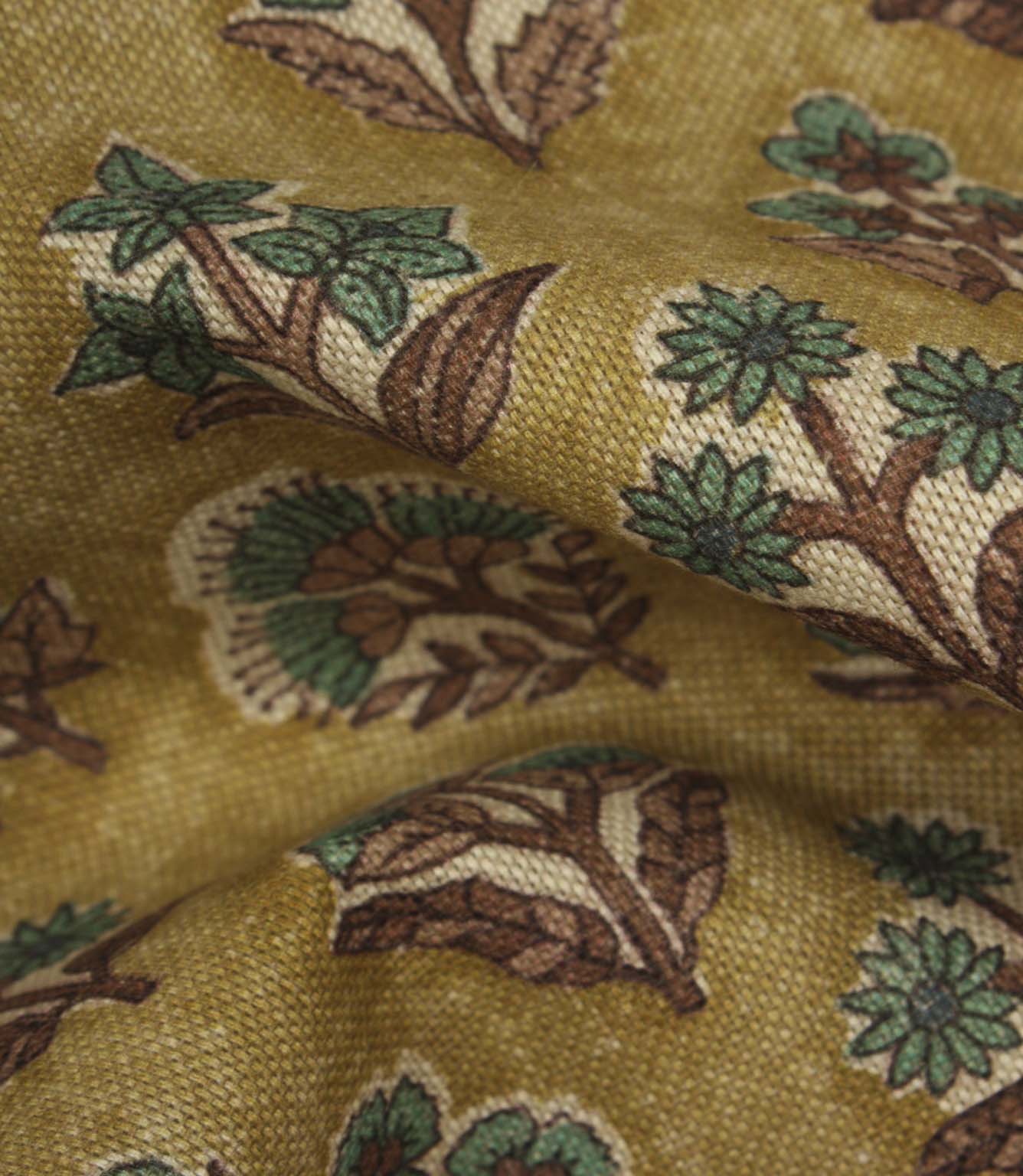 Close-up detail of Boho Blossom fabric showing the textured weave and teal floral design on a mustard yellow background.