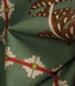 Detailed close-up of Boho Trail Mineral fabric featuring terracotta botanical stripes, geometric motifs and a soft mineral green background.