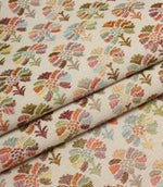 Folded Briar Sprig Jasmine woven fabric highlighting the detailed floral and foliage pattern in soft pink, sage, blue, terracotta and mustard shades.