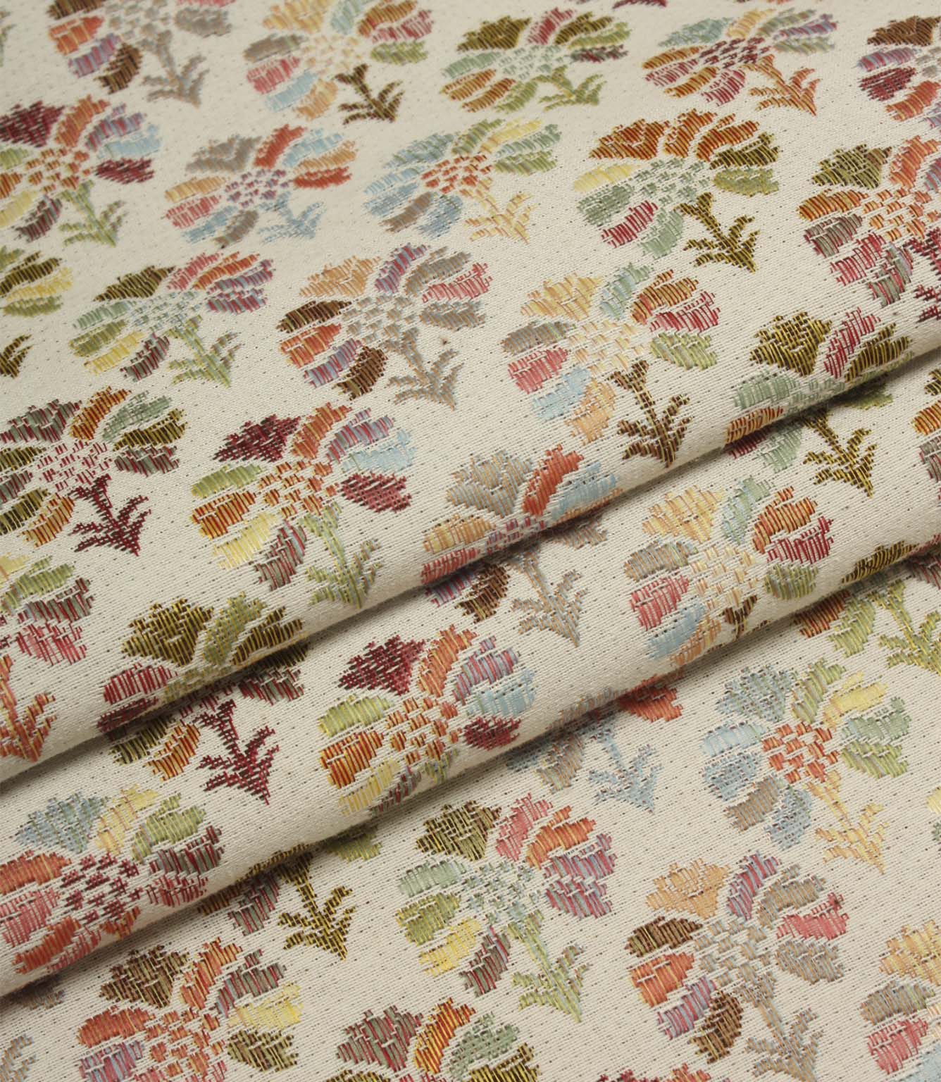 Folded Briar Sprig Jasmine woven fabric highlighting the detailed floral and foliage pattern in soft pink, sage, blue, terracotta and mustard shades.