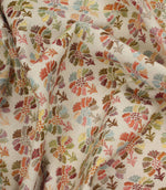 Draped Briar Sprig Jasmine contemporary floral fabric showcasing its woven texture and multicoloured botanical design on a natural cream background.