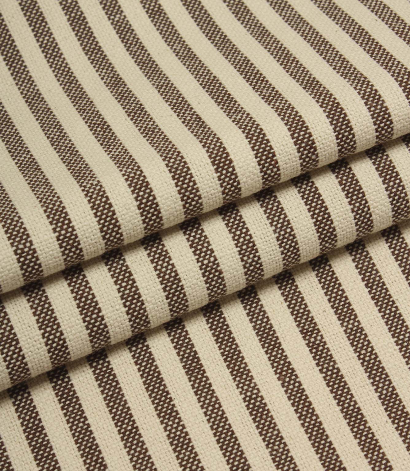Folded Broadway Stripe Mocha woven fabric displaying classic brown and cream ticking-style stripes, suitable for upholstery, curtains and cushions.