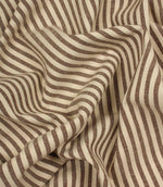 Draped Broadway Stripe Mocha striped fabric showing its soft handle, woven texture and elegant brown stripe pattern on a natural cream background.
