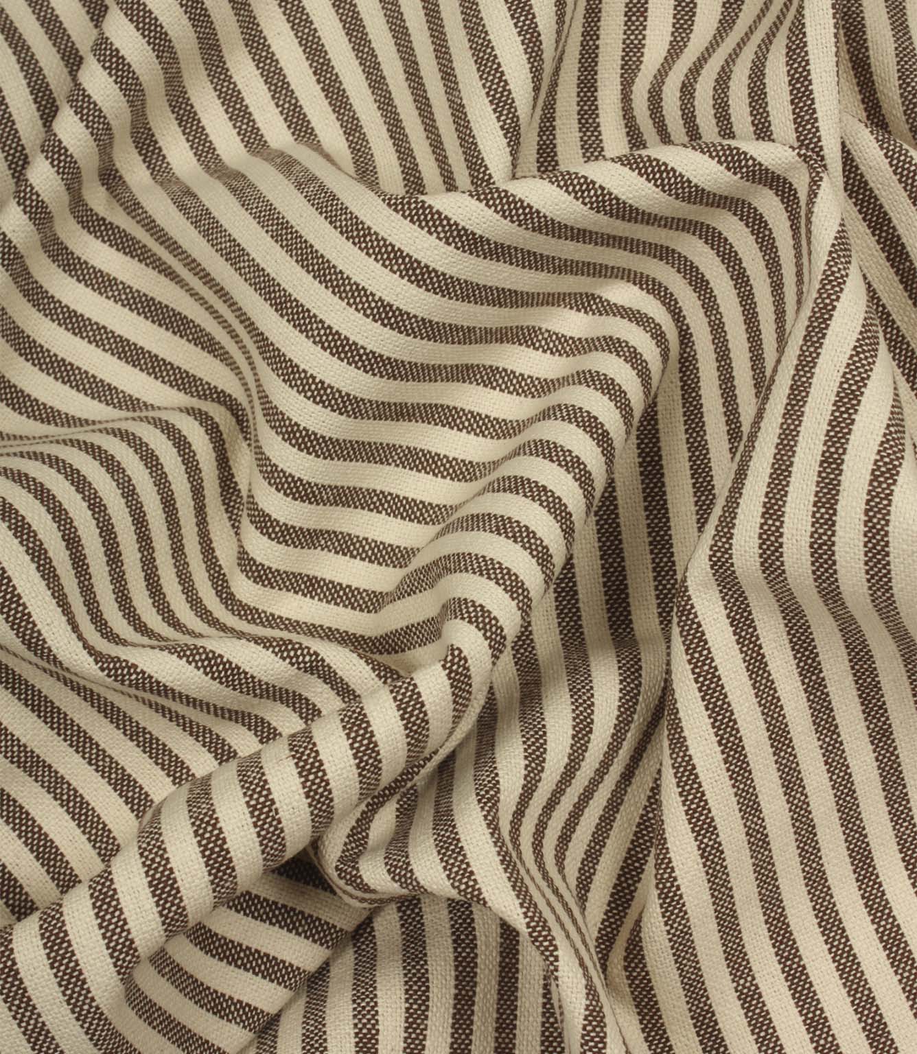 Draped Broadway Stripe Mocha striped fabric showing its soft handle, woven texture and elegant brown stripe pattern on a natural cream background.