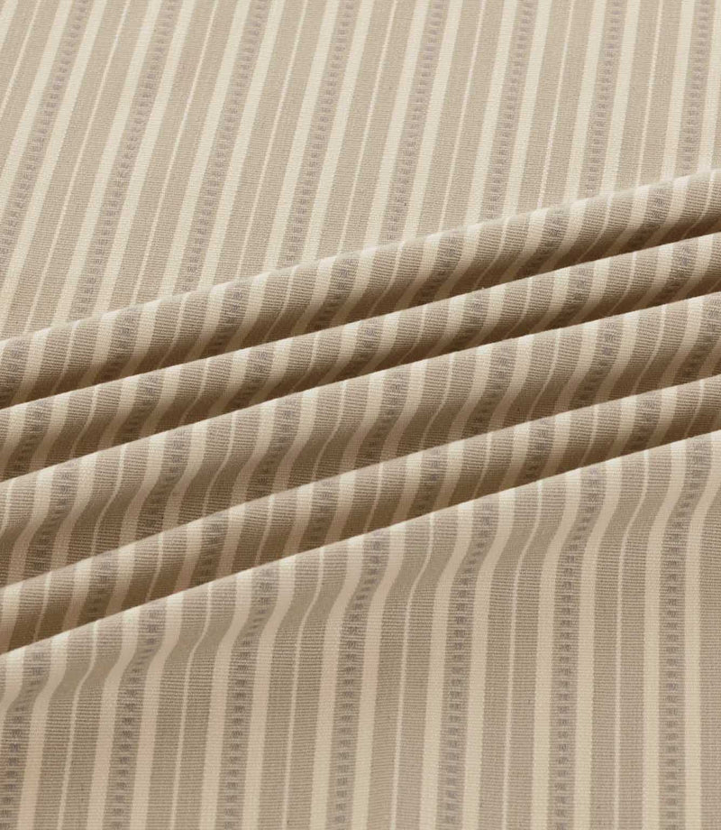 Close-up of Brookhaven Gull striped fabric in soft flowing folds, displaying neutral taupe and cream stripes with subtle dotted detailing and woven texture.