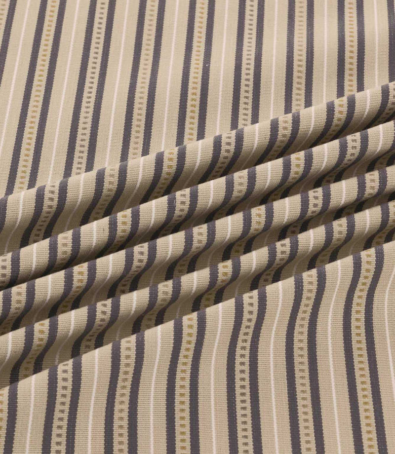 Close-up of Brookhaven Rockport fabric draped in gentle folds, revealing charcoal grey and taupe stripes with cream detailing and a textured woven appearance.