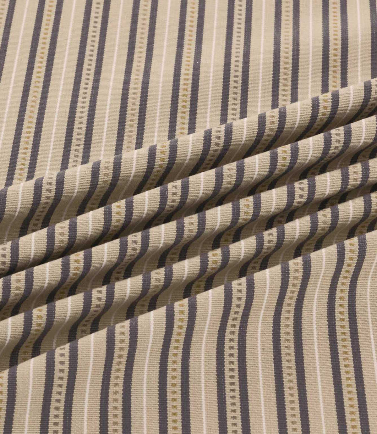 Close-up of Brookhaven Rockport fabric draped in gentle folds, revealing charcoal grey and taupe stripes with cream detailing and a textured woven appearance.