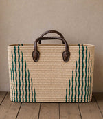 Woven basket tote bag with green stripes and brown leather handles