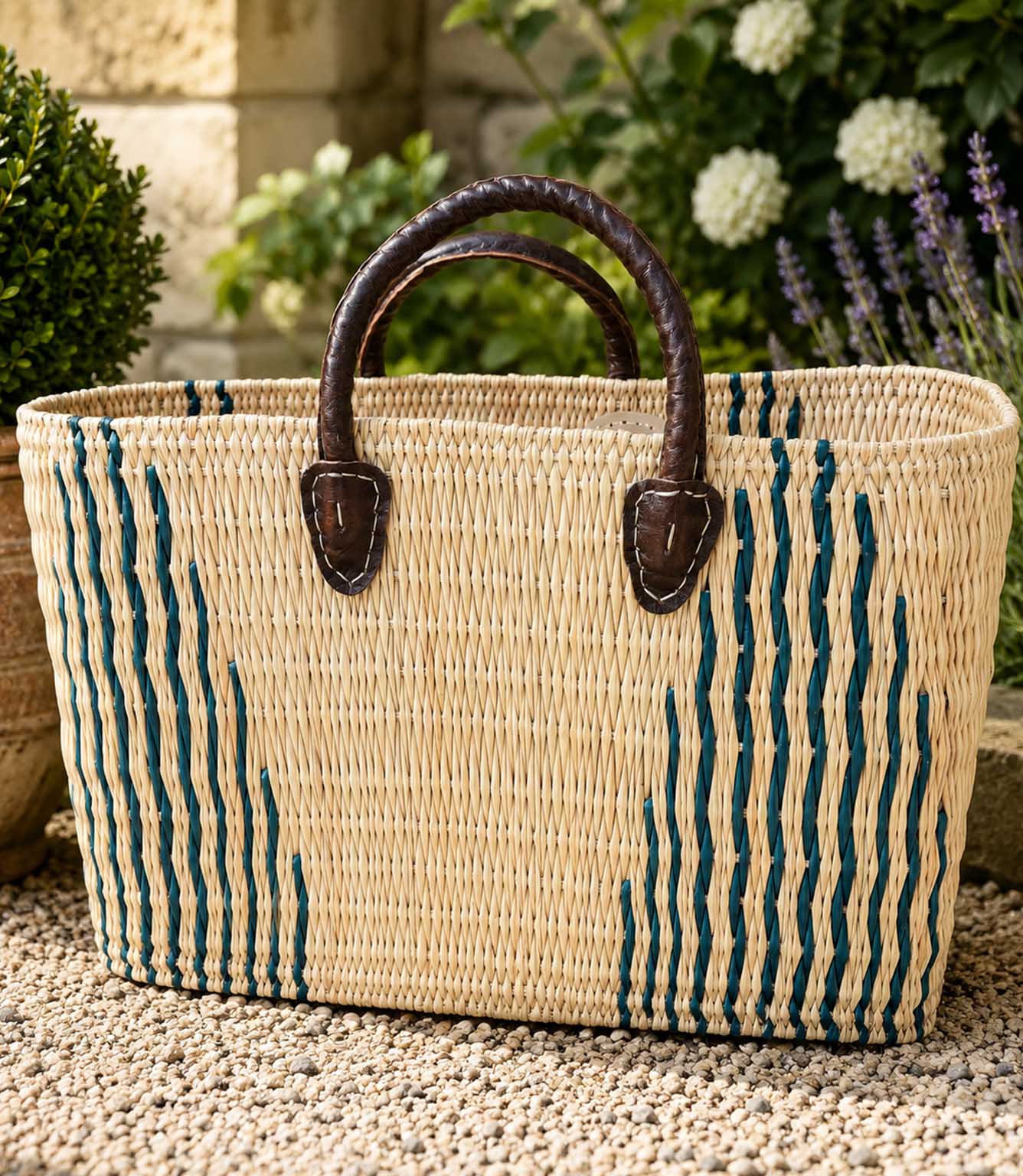 Woven basket tote bag with green stripes and brown leather handles